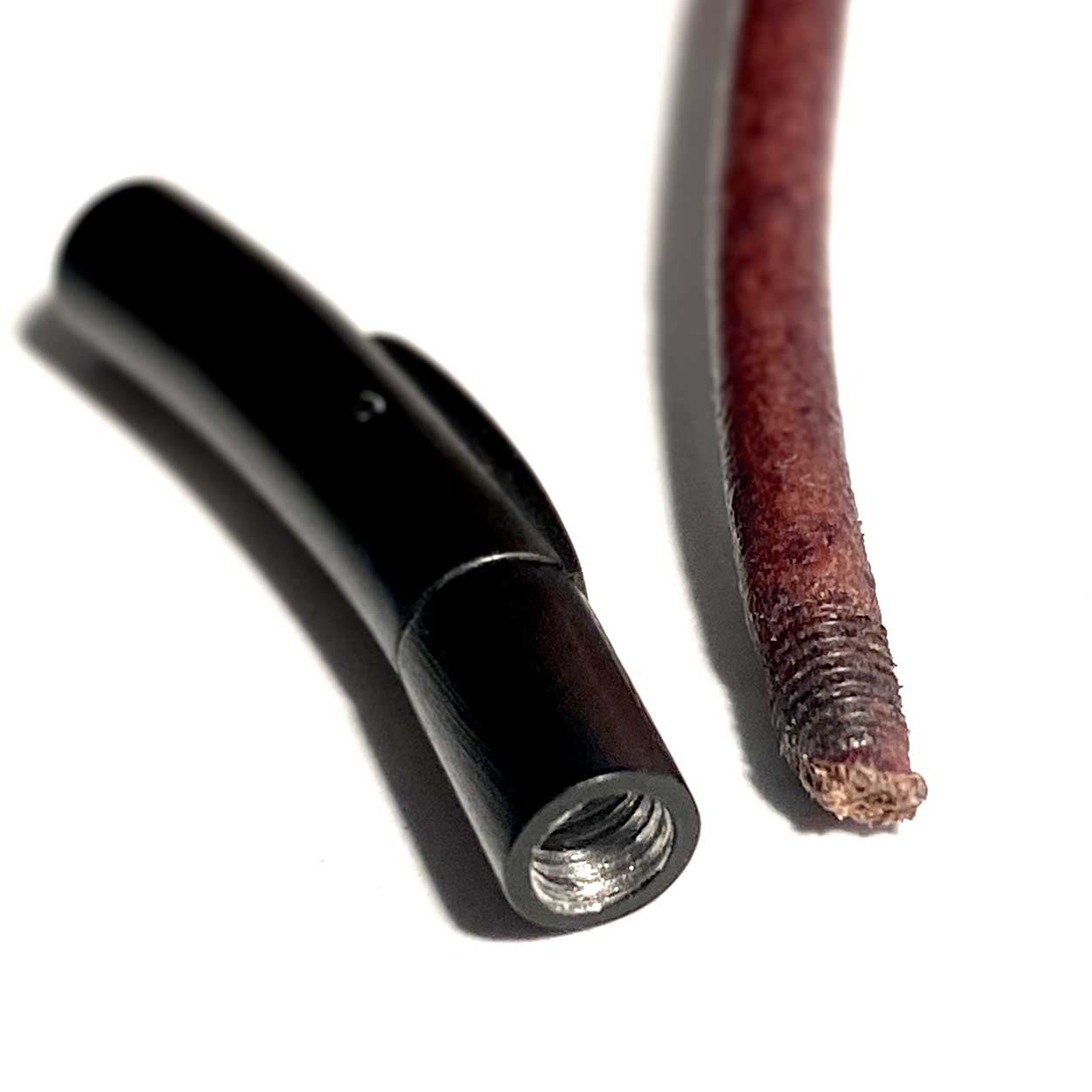 Black metal fitting and brown leather strap on a white background