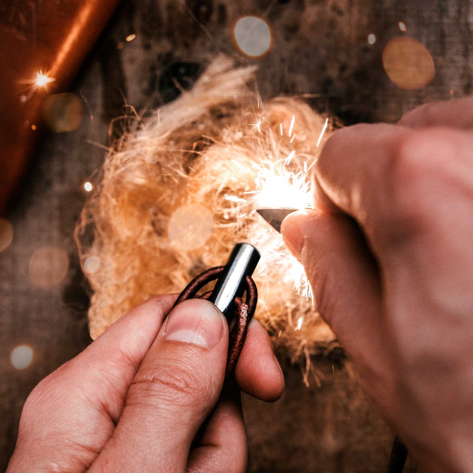 Person lighting a sparkler with a blurred background