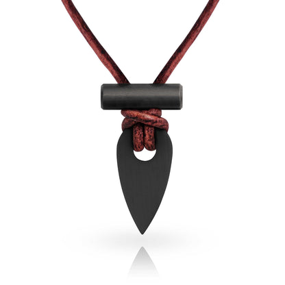 Black arrowhead pendant on a red cord against a white background