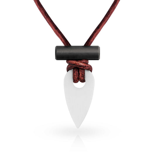 Necklace with a white pendant and black accent on a red cord against a white background